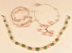 A matching silver bangle and necklace set with rose quartz beads together with a beaded rose