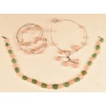 A matching silver bangle and necklace set with rose quartz beads together with a beaded rose