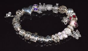 Pandora silver bracelet with over twenty Pandora silver charms including sheep, butterfly, dog,