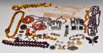 A collection of costume jewellery including watches, silver brooches set with marcasite, brooches,