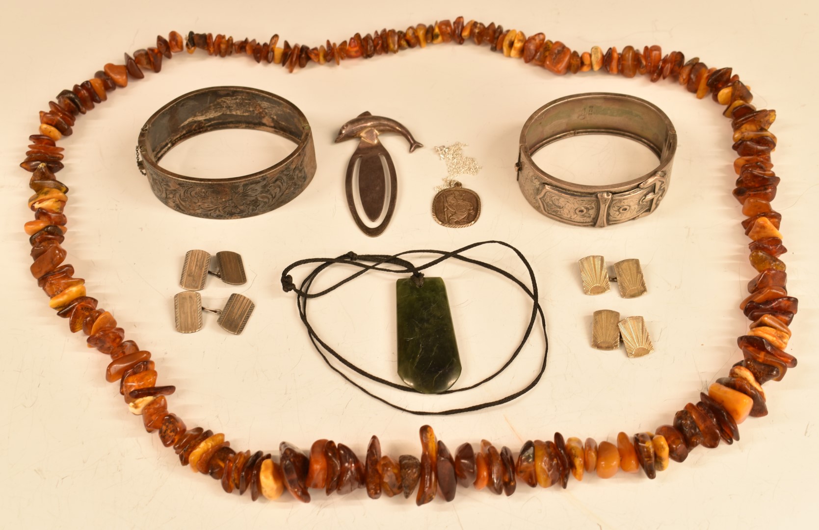A group of silver items including two bangles, bookmarks and cufflinks, a nephrite jade pendant