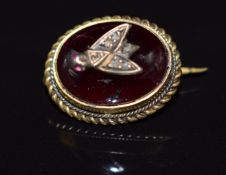 Victorian brooch set with a garnet cabochon mounted with a fly to the centre set with diamonds and