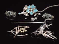 A silver brooch set with turquoise and seed pearls, two silver brooches, horseshoe stick pin and a
