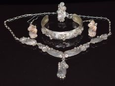 A suite of silver Navajo jewellery comprising bangle, necklace, ring and earrings