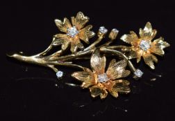 A 9ct gold floral brooch set with seven round cut diamonds, 6.6g, 4.5 x 2.5cm