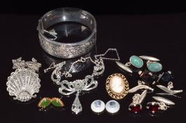 A collection of silver jewellery including bangle, brooch, cufflinks set with garnets, smoky