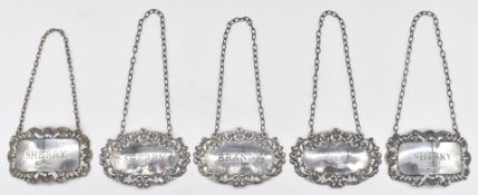 Five hallmarked silver bottle tickets comprising set of three Gin, Sherry and Brandy and a pair