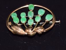 A 14k gold continental brooch set with jade cabochons, 3.8 x 3.1cm