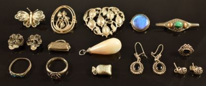 A collection of silver jewellery including earrings, brooches, rings, mother of pearl pendant,