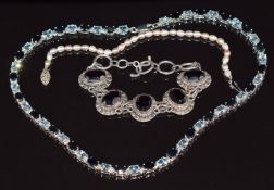 A silver necklace set with oval cut sapphires and topaz, silver bracelet and pearl bracelet