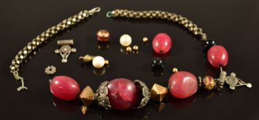 A beaded necklace made up of agate, silver and yellow metal beads
