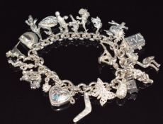 A silver Australian themed charm bracelet including duck billed platypus, boomerang, dunny,