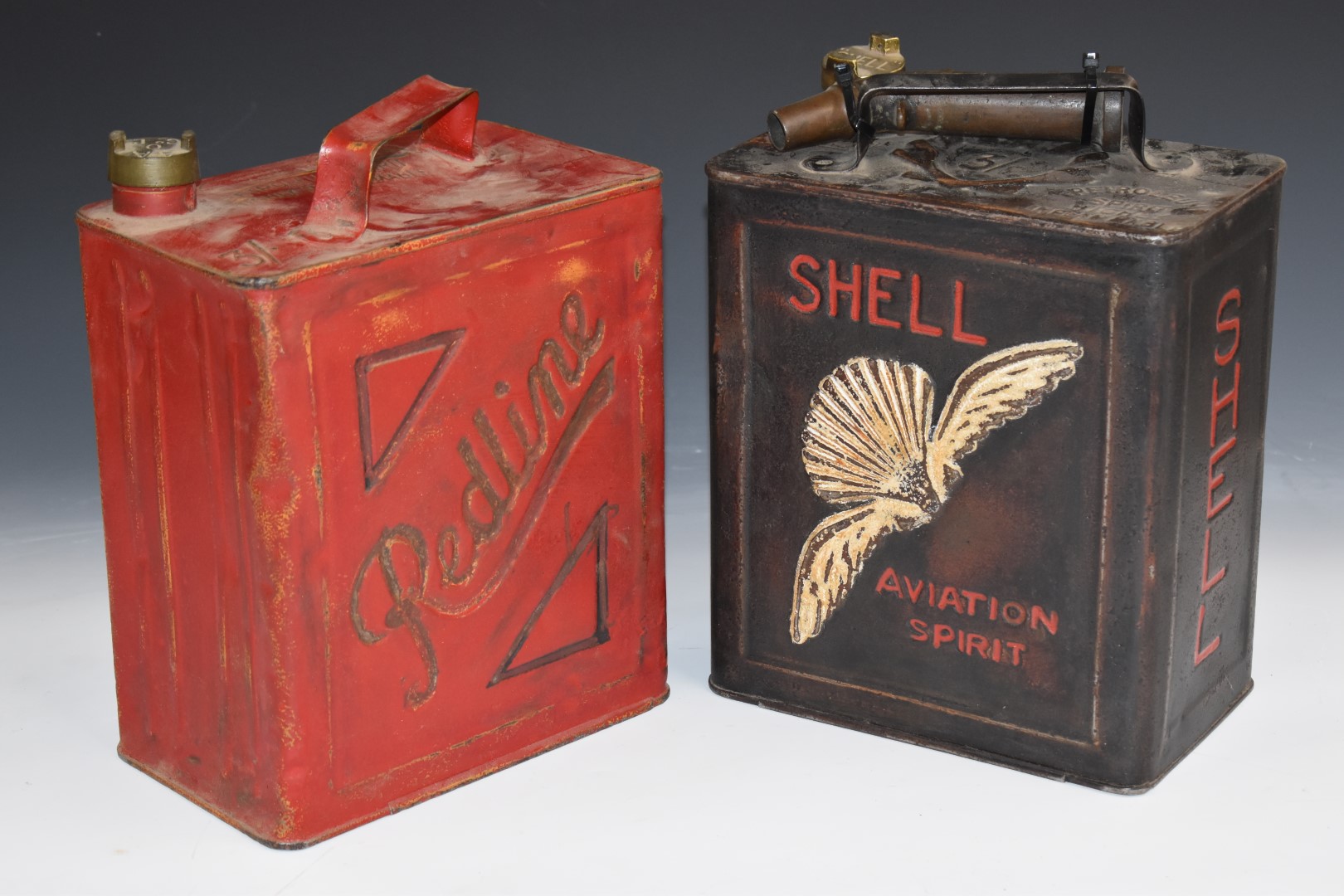 Two vintage 2 gallon vintage car petrol cans comprising Shell Aviation (1934) and Redline (1939),