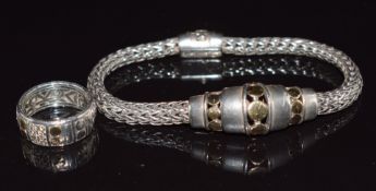 A designer silver and 18ct gold bracelet and diamond set ring