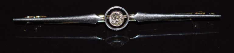 An 18ct gold and platinum brooch set with an old cut diamond measuring approximately 0.25ct, 6cm