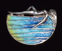 Norman Grant silver pendant depicting a woman sunbathing by water, set with blue enamel, 2.7 x 2.