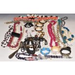 A collection of costume jewellery including bangles, two silver mounted items, beads, abalone