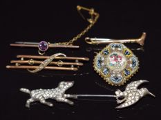 Three 9ct gold brooches, a micro mosaic brooch and a white metal paste set jabot pin in the form
