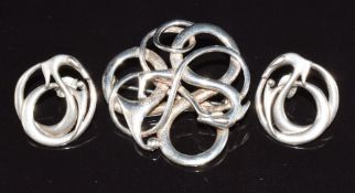 A silver brooch and matching earrings by Ola Gorie