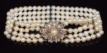 A four strand pearl bracelet, the 9ct gold clasp set with a further pearl and rose cut diamonds,