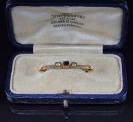 A 9ct gold brooch set with an amethyst and seed pearls, in vintage box