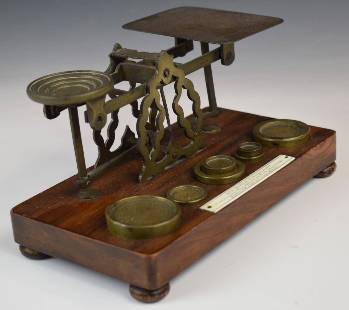 Mordan & Co. Victorian brass postage scales, on wooden base with weights and with postage rates to - Image 5 of 5