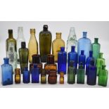 A collection of vintage glass bottles including two 19thC gin, poison, three Cardiff beer, malt,