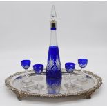 Blue flash overlaid cut glass liqueur set comprising decanter with silver plated mount and four