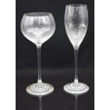 A set of ten WMF wine glasses with WMF stickers, together with a set of twelve champagne flutes,
