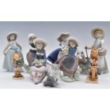 Six Lladro girl figurines, Lladro cat and two Goebel Hummels, tallest 22cm