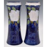 Royal Doulton pair of vases decorated with flowers, impressed BN mark to base, probably Bessie