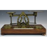 Mordan & Co. Victorian brass postage scales, on wooden base with weights and with postage rates to