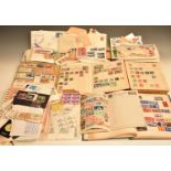 A collection of stamps and first day covers in albums including the Strand and loose including