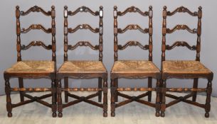 Set of four rush seated oak ladder back dining chairs