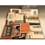 A collection of modern GB first day covers and presentation packs in three folders and loose.