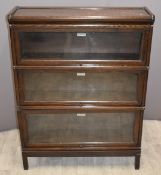 Globe Wernicke oak three tier bookcase with up and over glazed doors, W87 x D26 x H114cm