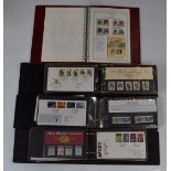 Four stamp albums including first day covers