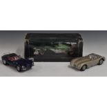 Three 1:18 scale die-cast models comprising Autoart Jaguar XK SS, Jaguar C-Type and Hotwheels 2000
