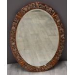 Arts and Crafts copper framed mirror with vine or similar decoration and with bevelled glass,