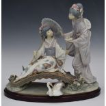 Lladro limited edition of 1500 figure of two Japanese ladies with flowers on a bridge, on wooden