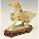 Chinese carved jadeite or similar hardstone horse on wooden base, 18cm tall.