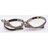 A pair of late 19th/ 20thC silver filigree and tortoiseshell bracelets, each in the form of a dragon