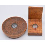 Two Chinese wooden cased compasses/ sun dials, the largest 7.5cm diameter