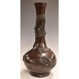 Japanese bronze pedestal bottle vase decorated with birds and dragons in relief, 40cm tall.