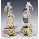 A pair of 19th/20thC German figural candlesticks, probably Volkstedt, H29.5cm