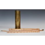 Four swagger sticks including three with bamboo shaft, together with a brass artillery shell,