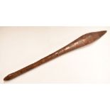 Polynesian or similar tribal club with incised decoration and remnants of old label, 65cm long.