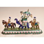 Indian white metal and enamel figural group in the form of figures riding a horse, an elephant and a