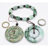 Two Chinese jade rings, carved bead bracelet and two pendants
