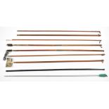 Eight various wooden and metal shotgun and rifle cleaning rods.